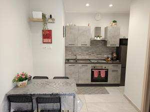 a kitchen with a table and a stove top oven at La casa di Flò in Ercolano