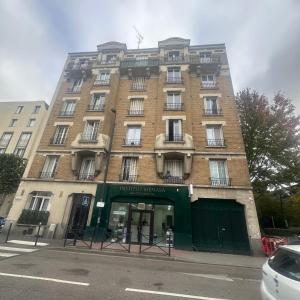 a large brick building on the corner of a street at Azal france in Vanves