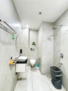 a white bathroom with a sink and a toilet at The Olivia -Luxury Apartments in Rishīkesh