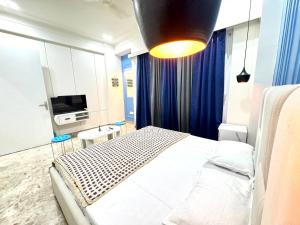 a bedroom with a bed and a television in it at The Olivia -Luxury Apartments in Rishīkesh