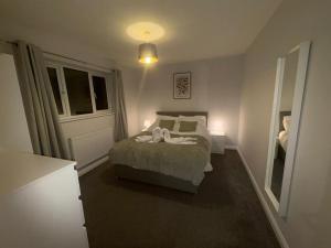 a small bedroom with a bed and a window at Large 4 bedroom Family let, Contractor, Corporate in Market Harborough