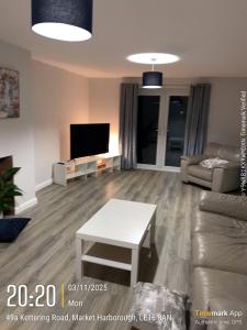 a living room with a couch and a table at Large 4 bedroom Family let, Contractor, Corporate in Market Harborough