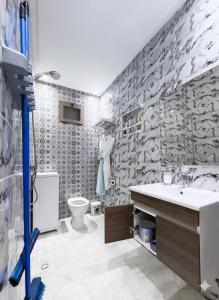 a bathroom with a sink and a toilet at Hotel America Apartments in Dakhla
