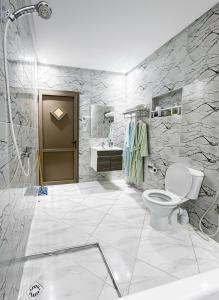 a bathroom with a toilet and a sink and a shower at Hotel America Apartments in Dakhla +54 photos