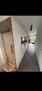 an empty room with a kitchen and a stairway to a kitchenasteryasteryastery at Chalet Home Texel in De Koog