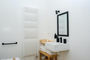 a bathroom with a white sink and a mirror at Dolcevita guest house in Torreano