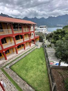 a building with a grass yard in front of it at Hotel Adulam in San Pedro La Laguna +23 photos
