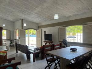 a living room with a table and chairs at Casa em Itamaracá - 70 metros da Praia in Itamaracá
