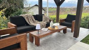 a patio with two couches and a coffee table at Vacation house SMEKI in Lokošin Dol