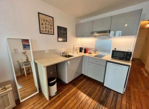 a kitchen with a sink and a counter top at Pilori 2 pers, separate bedroom, Tv wifi in Nantes +4 photos