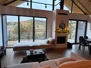 a large living room with a bed and a fireplace at Vamas Villa in Dobroselica