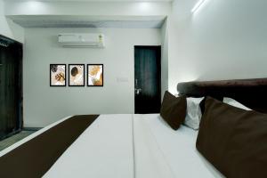 Ένα ή περισσότερα κρεβάτια σε δωμάτιο στο Hotel O H Pass