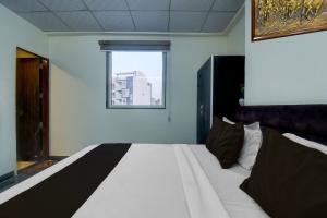 Ένα ή περισσότερα κρεβάτια σε δωμάτιο στο Hotel O H Pass