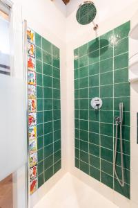 a bathroom with a shower with a green tiled wall at I Vigneti del Chianti in Barberino di Val dʼElsa +47 photos