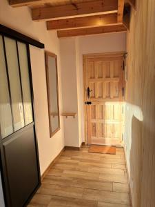 an empty hallway with a door and a floor at La Herrería de Somo 1 in Somo +6 photos