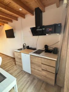 a kitchen with a sink and a microwave at La Herrería de Somo 1 in Somo