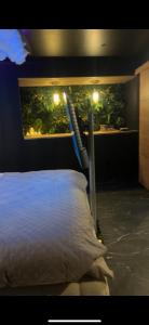 a bedroom with a white bed with lights on it at Ecrin secret in Aubagne