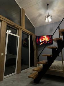 a room with a staircase with a fire in the ceiling at Field house in Slavske