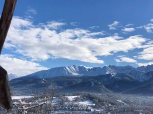 a view of snow covered mountains from a ski lift at Rochowa Buźnica Apartament 1 in Zakopane