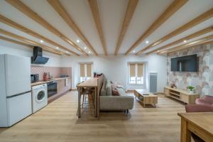 a living room with a table and a kitchen at Le Faro in Saint-Michel-de-Maurienne