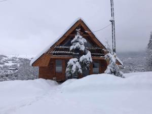 a log cabin with snow on the roof at Domek Rochowa Buźnica apartament 2 in Zakopane +4 photos