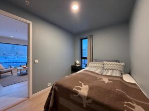 a bedroom with a bed and a large window at Luxury Panorama Apartment by the Sea with Northern Lights View in Tromsø