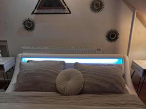 a bed with a pillow on it with two mirrors on the wall at Apartment THEA 100m2 for 5 guests in Mrše