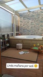 a bathroom with a tub and a table with a table at RELAX HOUSE PUNTA DEL DIABLO in Punta Del Diablo +20 photos
