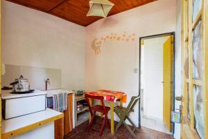 a small kitchen with a table and a stove at Cabañas rainbow in San Marcos Sierras