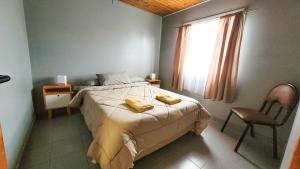 Ένα ή περισσότερα κρεβάτια σε δωμάτιο στο Hospedaje Rincón del Sur22