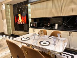 a dining room with a table and a fireplace at 7 Star Apartments in Tashkent