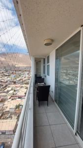 a balcony with a view of a city at Matiz Cavancha II in Iquique