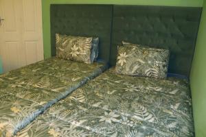 two beds sitting next to each other in a bedroom at Maison Royale Lodge in Nongoma