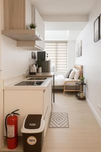 a kitchen with a sink and a counter top at Tala Haven at Azure North Studio with Mt Arayat View in San Fernando