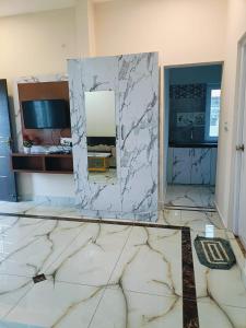 a bathroom with a mirror on a marble floor at Pure Vegeterian 2BHK Private Guest House - Air Cnditioned - WiFi - Full Kitchen - No Alcohol Zone - Hilltop Heaven in Yelagiri
