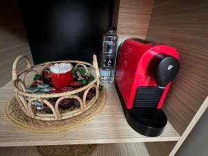 a red toaster and a basket on a table at Abe Studio in Craiova