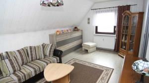 a living room with a couch and a table at Ferienwohnung Kresse 