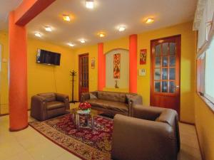 a living room with a couch and chairs and a table at Hotel Inka Luxe in Arequipa