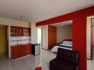 a bedroom with a bed with a red wall at Hotel Inka Luxe in Arequipa