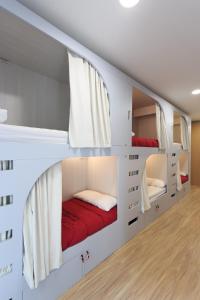 a bedroom with a bed and a dresser at Albergue de Pamplona-Iruñako in Pamplona
