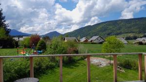 a view of a field with a playground and mountains at Chez Mat in Lans-en-Vercors