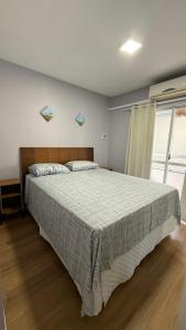 Una cama o camas en una habitación de Residencial Solar das Bromélias