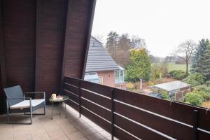 a balcony with a table and chairs and a view at Design-Apartment Worpswede in Worpswede