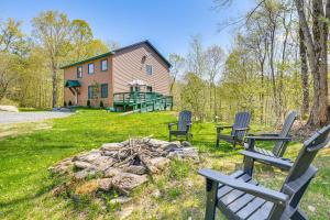 a group of chairs around a fire pit in front of a house at Fish, Hike and Ski Spacious Family Escape in Eden in Eden
