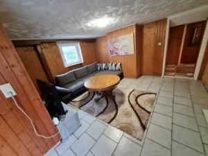 a living room with a couch and a table at Ramstein Wohnung in Ramstein-Miesenbach +2 photos