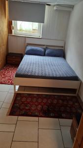 a bed in a small room with a rug at Ramstein Wohnung in Ramstein-Miesenbach