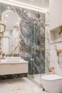 a bathroom with a shower and a toilet and a sink at Nest One Luxe, Элитные апартаменты с террасой и панорамным видом 067 in Tashkent +58 photos