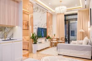 a living room with a bed and a kitchen at Nest One Luxe, Элитные апартаменты с террасой и панорамным видом 067 in Tashkent