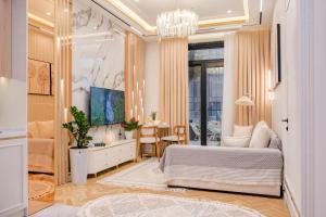 a living room with a bed and a table at Nest One Luxe, Элитные апартаменты с террасой и панорамным видом 067 in Tashkent