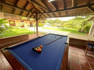a pool table with cue balls on top of it at La muñeca Chalet in Circasia